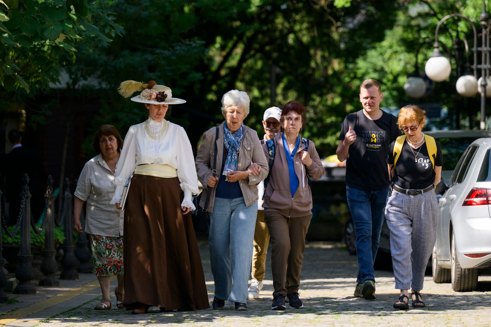 The group walking under the trees